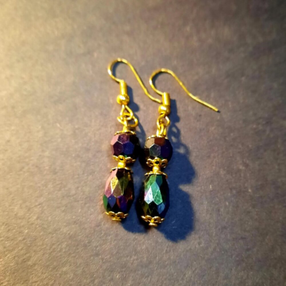 Unique and elegant with gold hardware. Black, purple, Green Iridescently colored